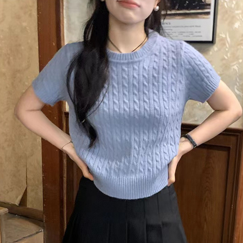 Person wearing blue sweater and black skirt.