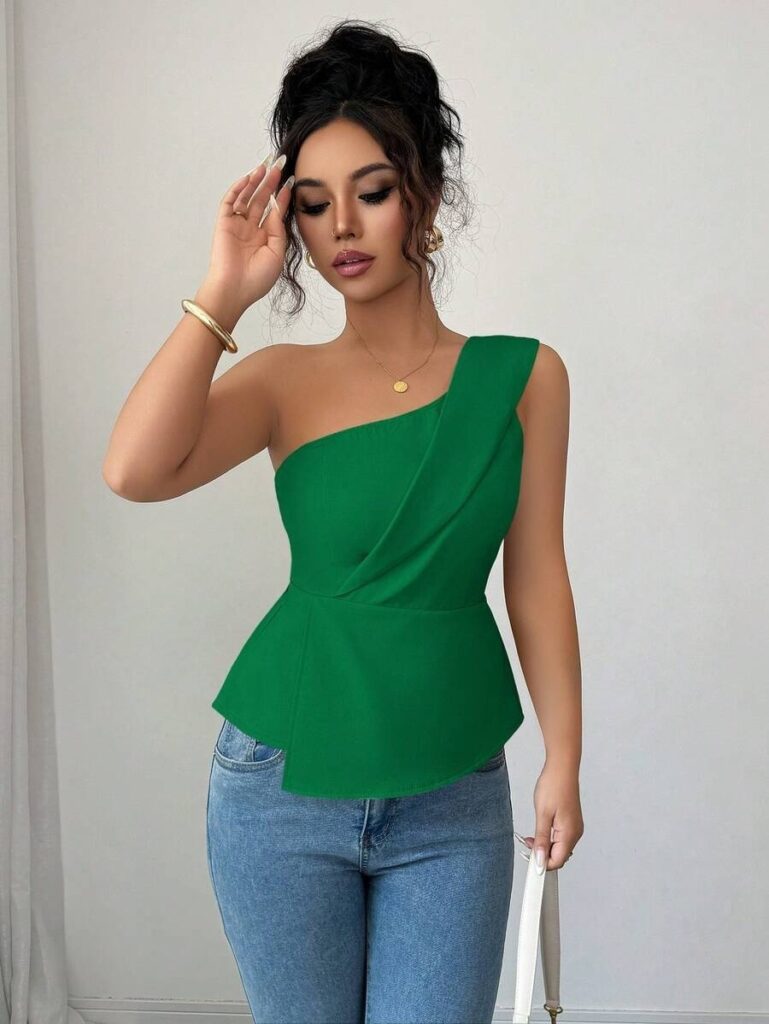 Woman in green top and blue jeans.