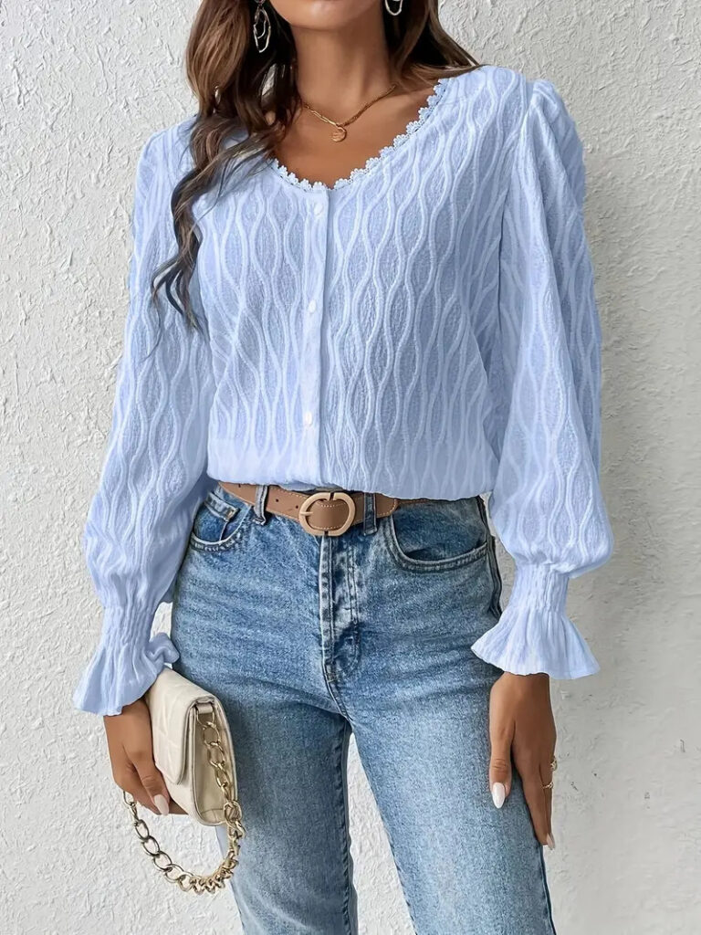 Woman in blue blouse and jeans outfit.