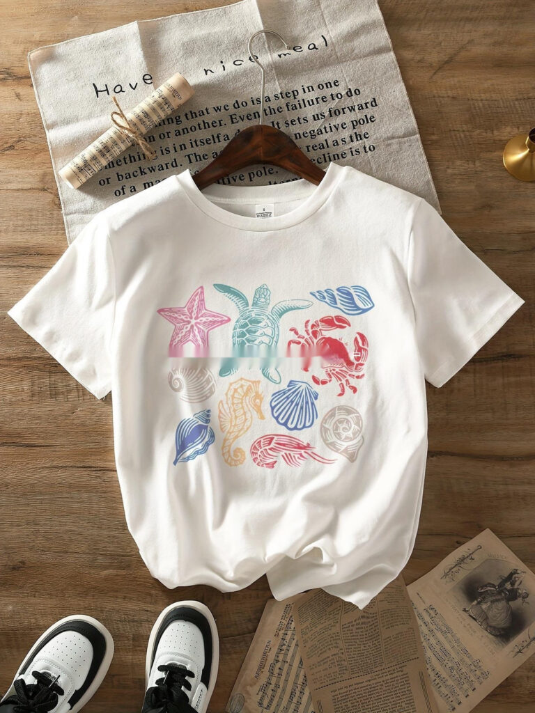 White t-shirt with colorful sea creature designs.