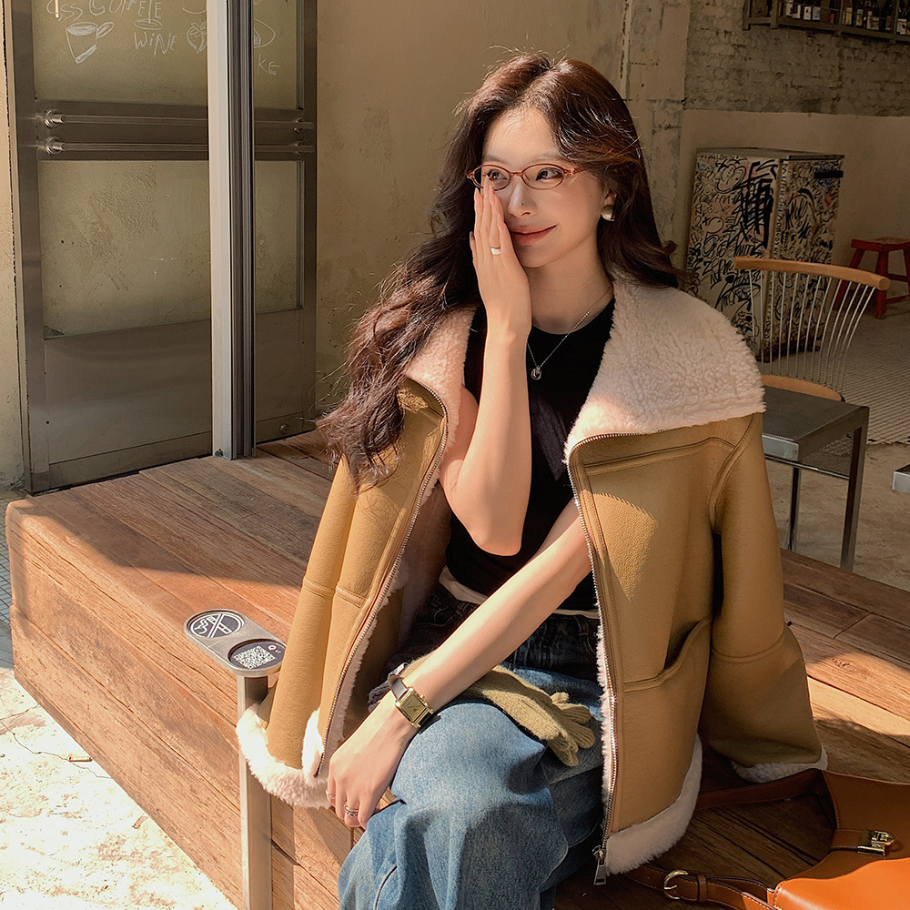 Woman sitting in cafe, covering her smile.