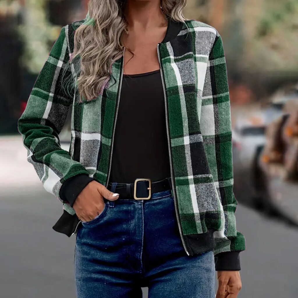 Person wearing green plaid jacket outdoors.