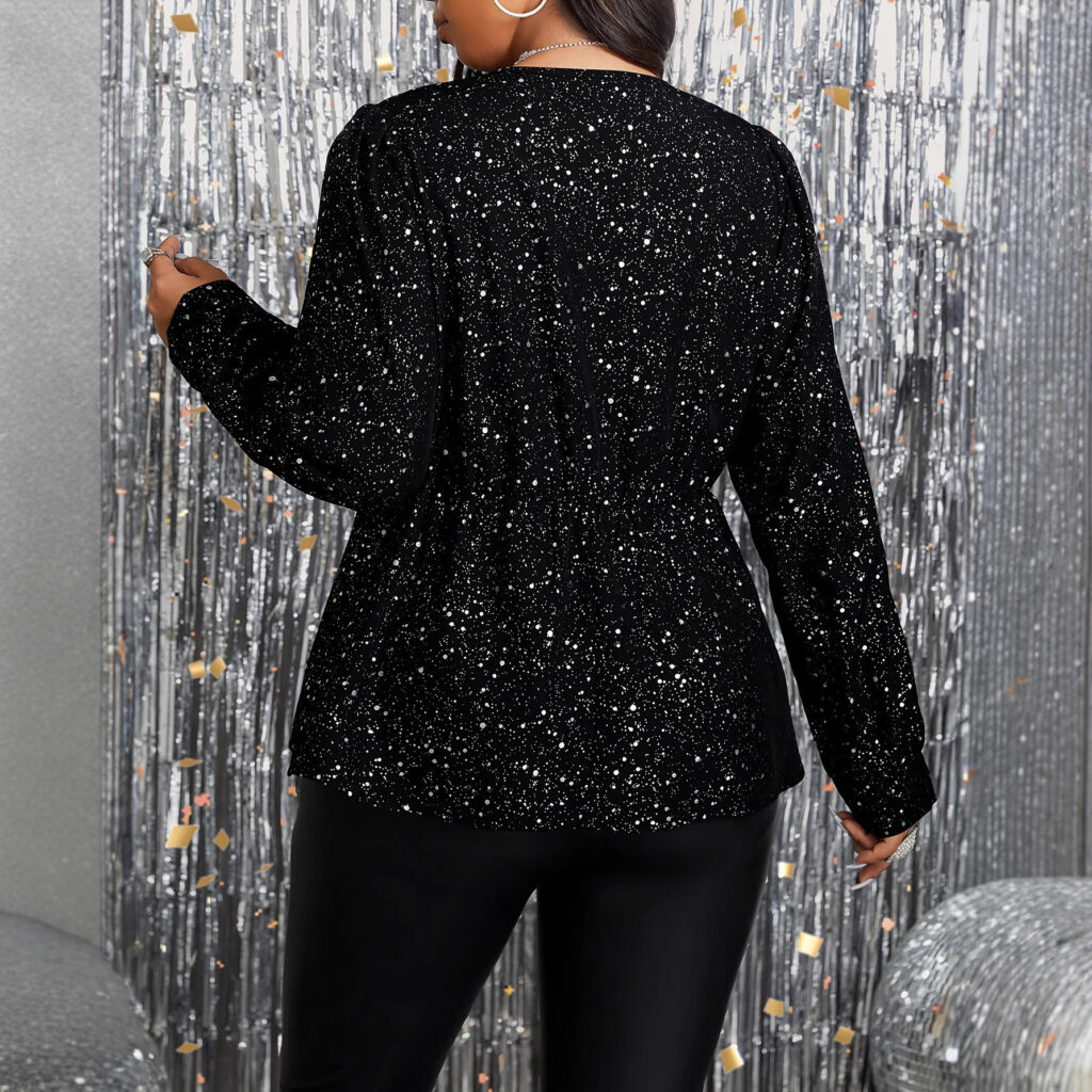 Woman in black sequin outfit, festive backdrop.