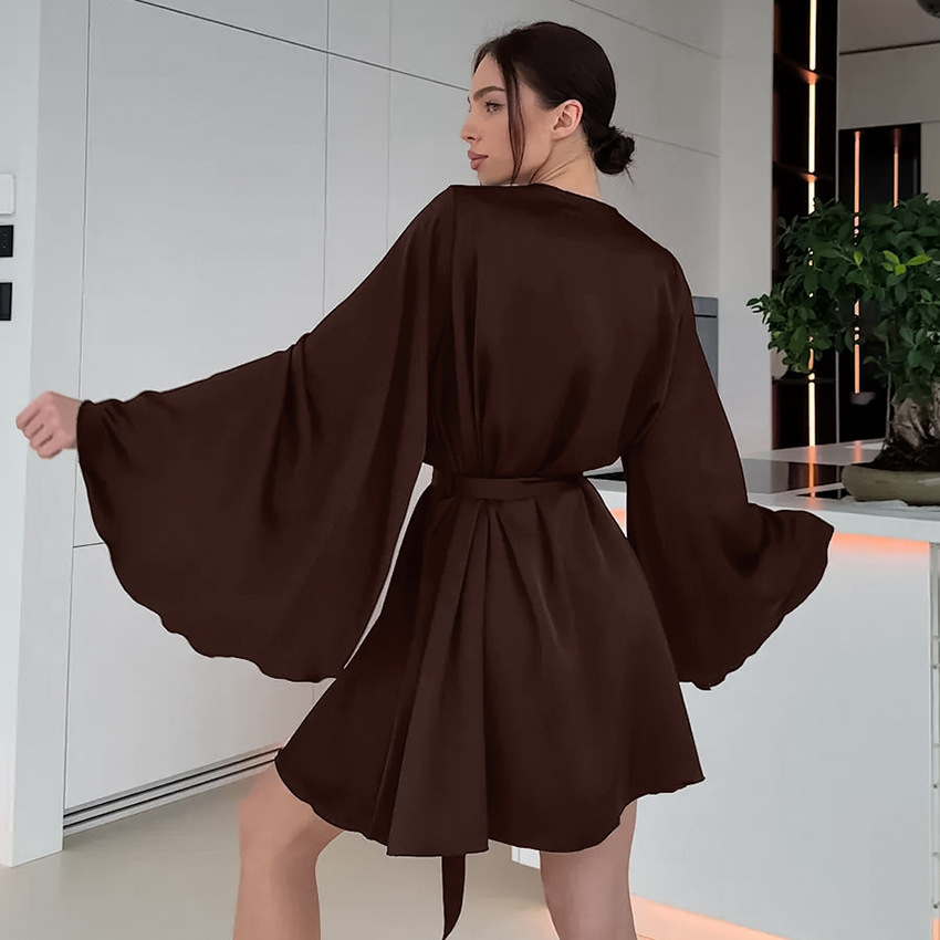 Woman in brown kimono-style dress indoors.